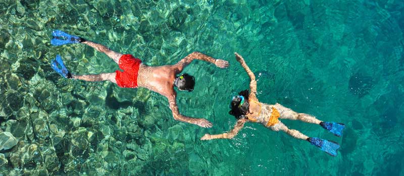 Couple Snorkeling At Phi Phi Island, Phuket, Thailand