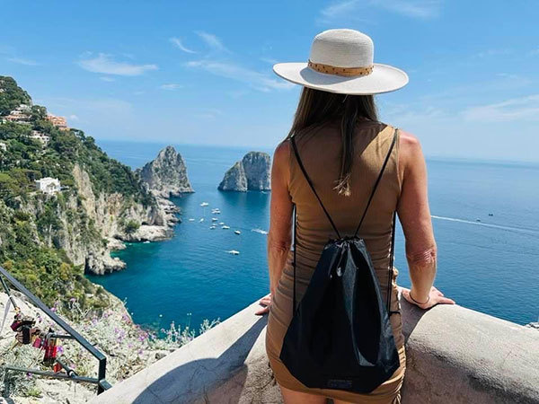 Famous Faraglioni rocks at Capri Island coast seen from the sea, Italy